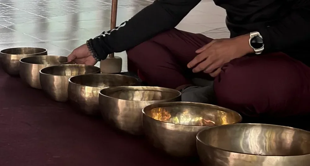 Hands and brass sound bowls during practice